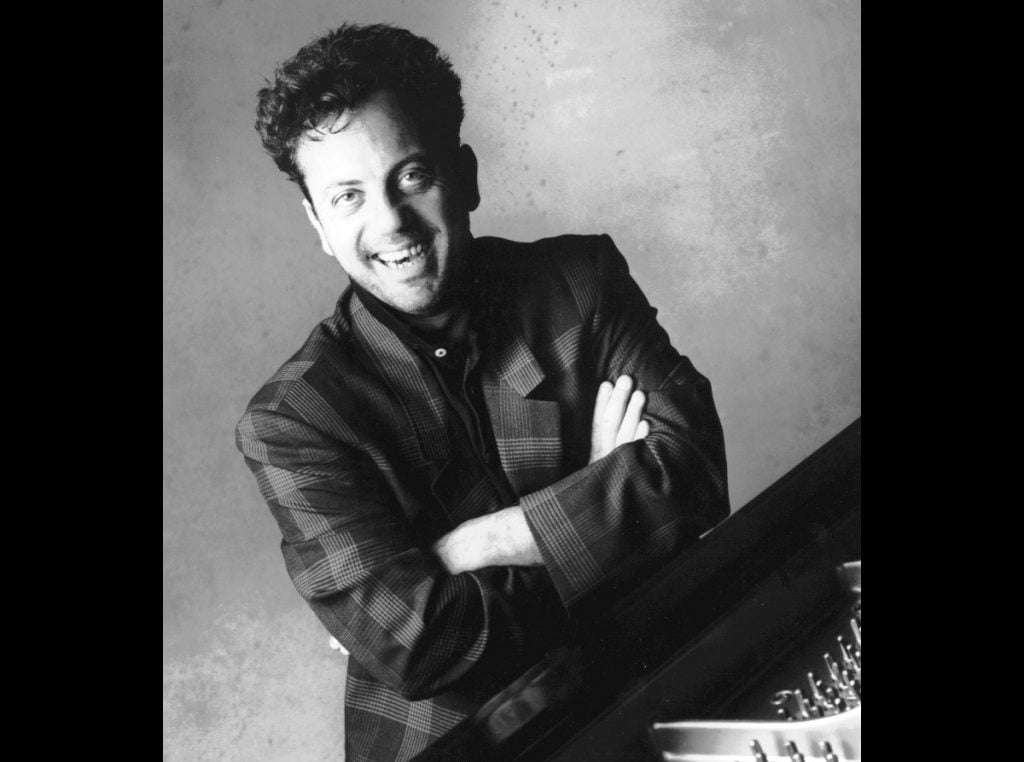bj-at-piano-arms-crossed-smile